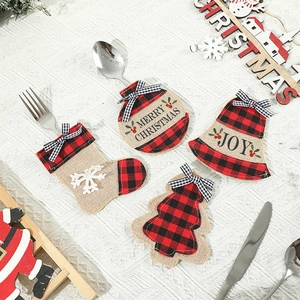 Plaid Christmas stocking and tree cutlery holders set on a rustic white table runner