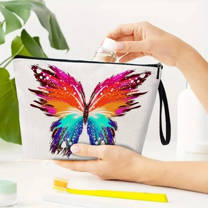 Off-white canvas butterfly cosmetic bag with black zipper and wristlet for travel