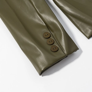 Detailed macro view of olive green faux leather sleeve with three decorative buttons
