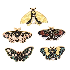 Set of five cute cartoon moth and butterfly enamel pins with gold metal botanical details
