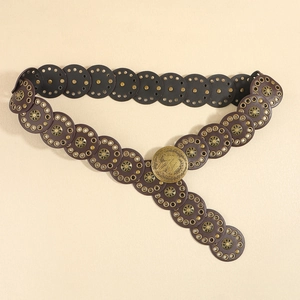 Detail of vintage Western-style belt with bronze embossed buckle and eyelet round leather pieces