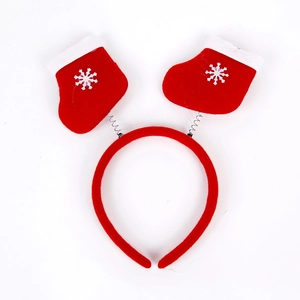 Detail of red Christmas headband featuring spring-mounted socks with white snowflakes