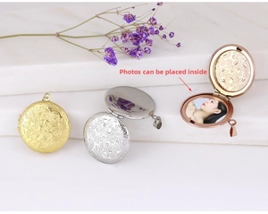 Detailed view of vintage engraved heart locket necklace in gold, silver and rose gold