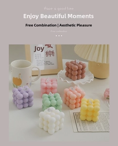Macro shot of assorted colorful pastel bubble cubes and textured aesthetic candle set