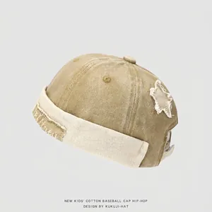 Close-up of kids' khaki retro brimless cap with star patch and embroidery detail
