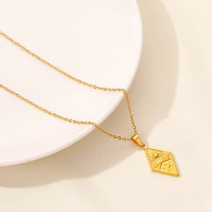 Detail shot of golden 18K plated stainless steel necklace with diamond-shaped moon pendant