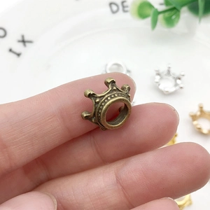 Macro detail of a bronze crown-shaped alloy charm for DIY jewelry and hair accessories