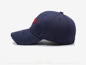 Detailed side view of navy blue distressed baseball cap with 3D red embroidery