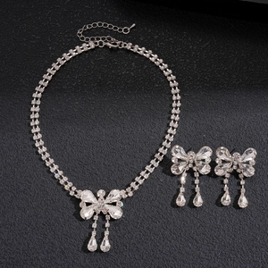 Silver bow necklace and earring set with sparkling rhinestones and teardrop tassels