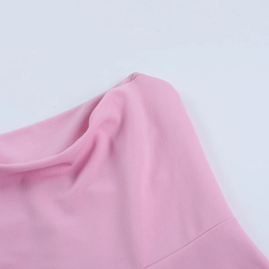 Detail of pink bodycon dress showing smooth fabric texture and natural elegant draping