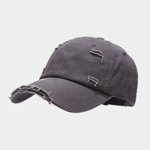Detailed view of the distressed edges and worn-out holes on the charcoal cotton baseball cap