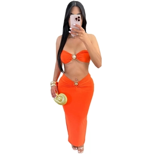 Sexy orange two-piece set with crop top, maxi skirt and golden shell accents