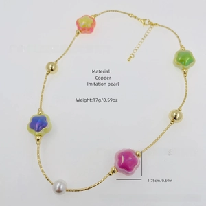 Detail of colorful flower pendant necklace with 18k gold plating and imitation pearls