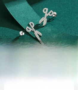 Detailed view of S925 sterling silver scissor earrings with sparkling zircon inlay