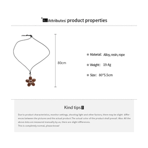 Detail view of oval resin flower pendant necklace with rope chain and alloy parts