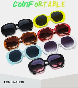 Flat lay of retro oversized sunglasses in multiple colors including black yellow and leopard