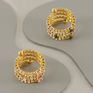 Detailed view of layered 18K gold ring with pink and black heart stones and zircons