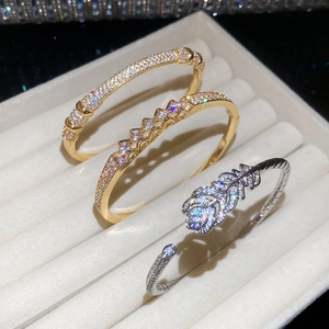 Detailed close-up of gold and silver plated bracelets with zirconia on a jewelry tray