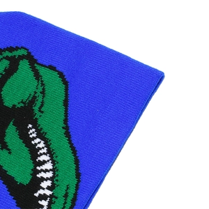 Detailed knit texture of a blue winter beanie featuring a green dinosaur mouth pattern