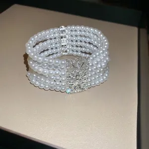 Elegant multi-layer pearl bracelet with a crystal-encrusted square hollow charm
