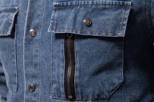 Close-up of heavy twill denim fabric with vintage metal buttons and zipper stitching