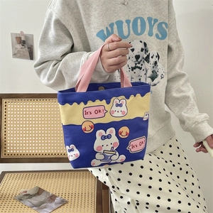 Detailed view of the cute cartoon rabbit canvas handbag with It's OK print