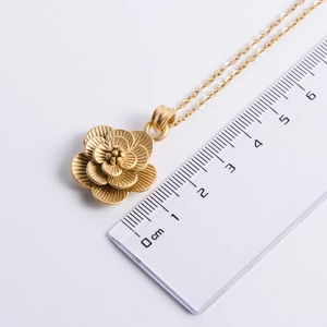 Gold 3D layered flower pendant necklace with matte finish and 2.5cm diameter on white background