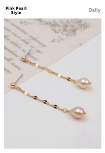 Detail of elegant long tassel earrings with pink drop-shaped pearls and gold chain link