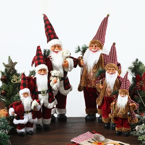 Standing Santa Claus figurines in red plaid and gold luxury outfits for holiday decor