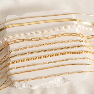 Detailed view of layered gold-plated stainless steel necklaces with freshwater pearls