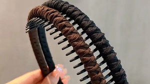 Detail of brown and black braided headbands with non-slip plastic inner teeth