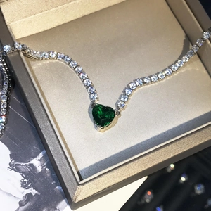 Luxury silver tennis necklace with heart-shaped emerald green gemstone in gift box