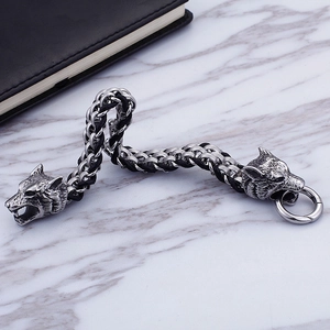 Vintage style braided leather bracelet with double wolf heads and stainless steel ring