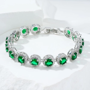 Detailed shot of emerald green zircon bracelet with micro-pave crystals on white stone