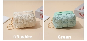 Close-up of quilted bubble texture coin purse with gold zipper and keyring detail