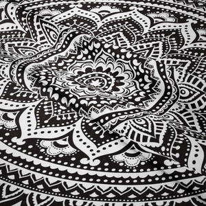 Detailed macro view of black and white mandala tapestry fabric texture and fold