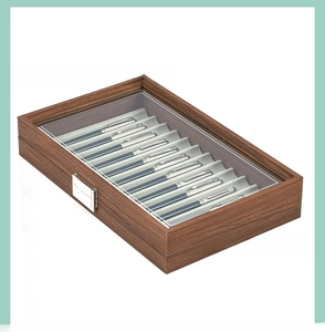 Macro view of walnut wood pen display box with 10 slots and transparent glass window lid