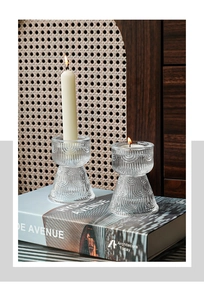 Close-up of ribbed glass candle holders with shell relief pattern in home setting