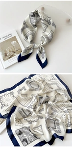 Detailed view of paisley silk scarf with elegant black and white print and navy blue borders