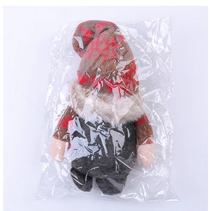 Close-up of knit Christmas gnome ornaments in plastic bags with snowflake hats