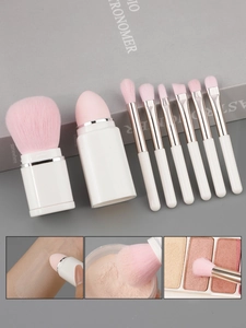 Macro detail of 8-in-1 makeup brush set with pink bristles and a beauty blender sponge
