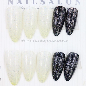 Long almond press-on nails with black and white glitter finish in 24-piece set