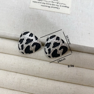 Retro cow print irregular triangle stud earrings in silver metal and black enamel