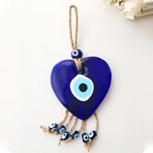 Heart-shaped glass Evil Eye hanging ornament with woven rope and blue bead tassels