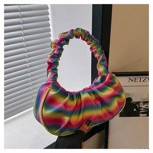 Detailed side view of the rainbow gradient pleated shoulder bag with a ruched handle