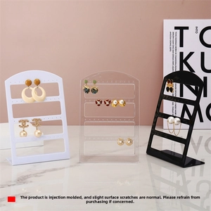 Three L-shaped jewelry stands in black white and clear acrylic for earring organization