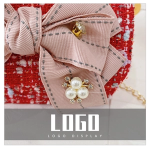Detail of red tweed bag with pink ribbon bow, pearls, rhinestones and golden chain