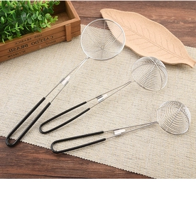 Three sizes of stainless steel mesh strainers with black silicone handles on a woven mat