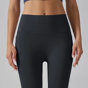 Detail view of high waist yoga leggings with functional side pockets in matte black