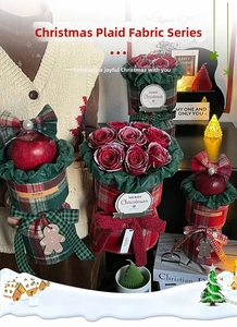 Detailed close-up of Christmas plaid fabric bouquet with red roses, apples and wooden charms